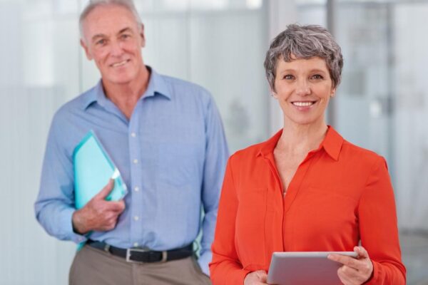 Theyre bringing expert experience to their business Two mature coworkers standing together in the office