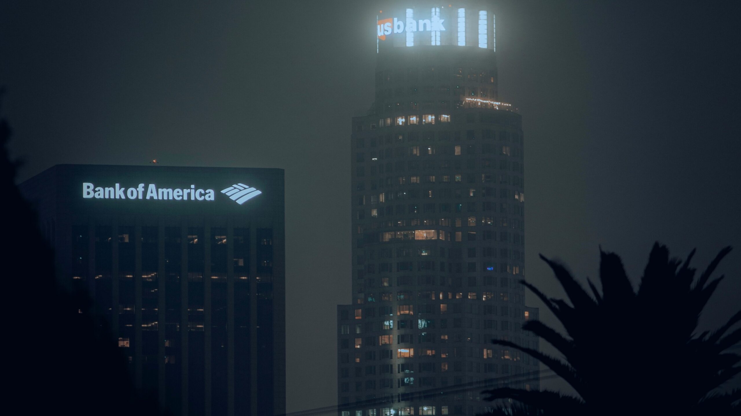 the bank of america building is lit up at night