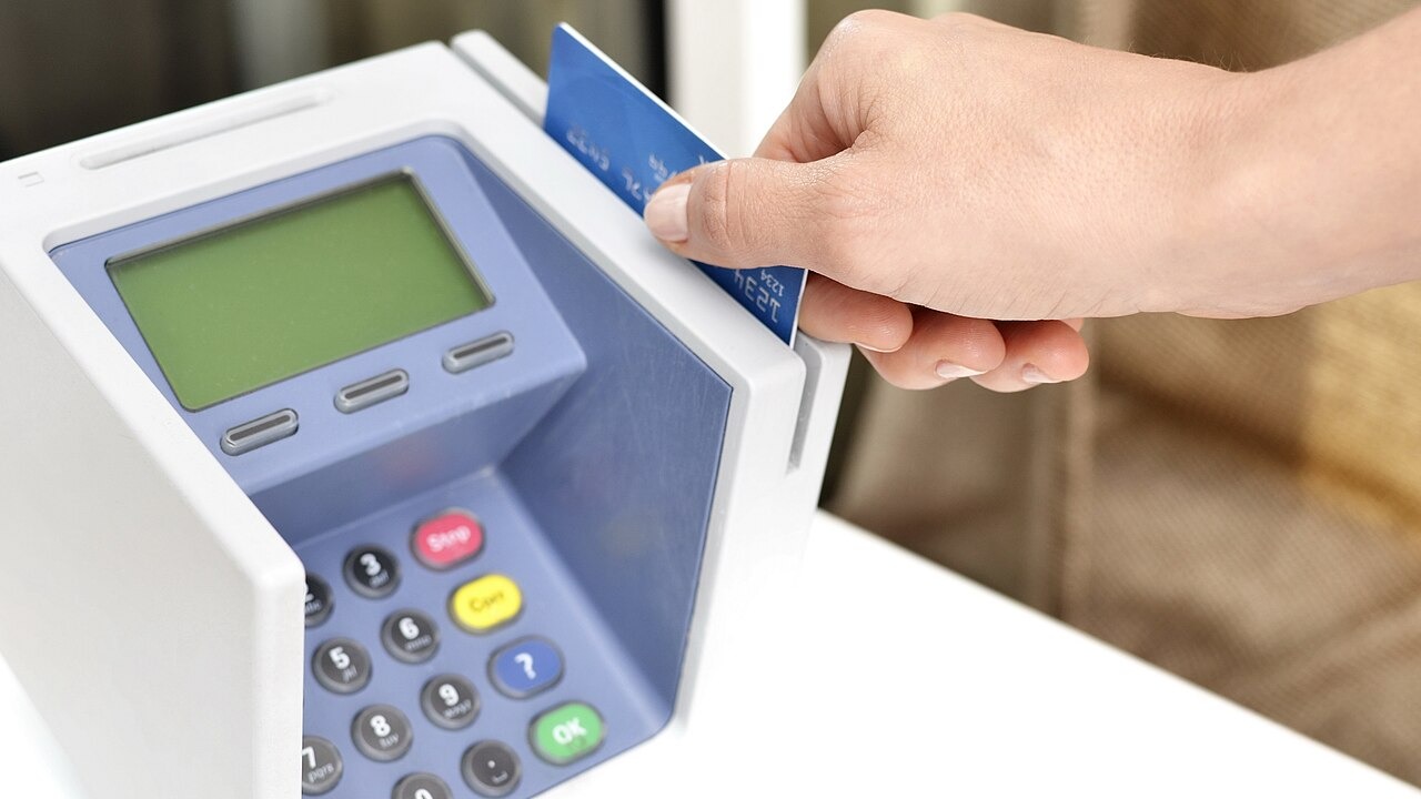 This photo shows a female hand sliding a debit or credit card through a blue point-of-sale machine. She could be making a retail purchase, or it could be a clerk or server processing payment at a store or restaurant. This picture would be good for illustrating purchases, business transactions, consumer buying habits, or purchasing convenience. Feel free to use them but please credit our website as the source, for example: Image: Hloom via Flickr / CC BY-SA, 401(K) 2013 Please add link to this image for "flickr", and link to our homepage hloom.com for "hloom"