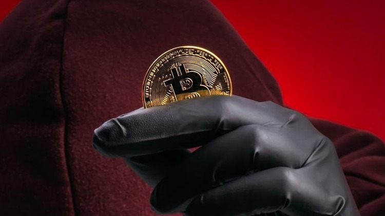 Crypto scam concept showing anonymous hacker stealing Bitcoin through phishing and fake investment schemes Cybercriminal targeting digital assets with fraud impersonation and high return promises