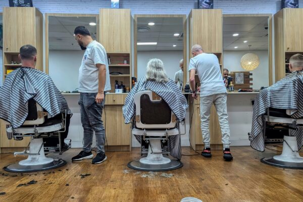 Barbers cutting hair in a modern salon