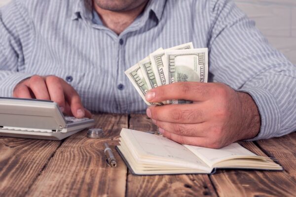 Businessman with calculator and dollars