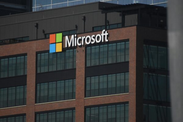 A tall building with a microsoft logo on top of it