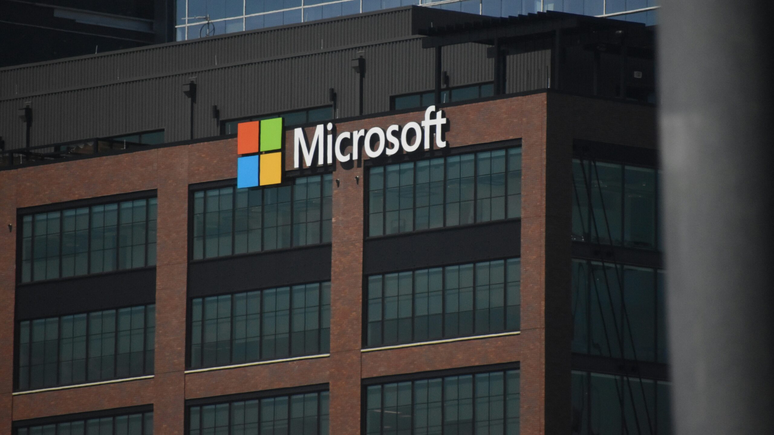 A tall building with a microsoft logo on top of it