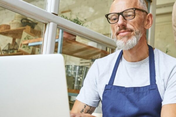 Middle aged caucasian business partners working on laptop