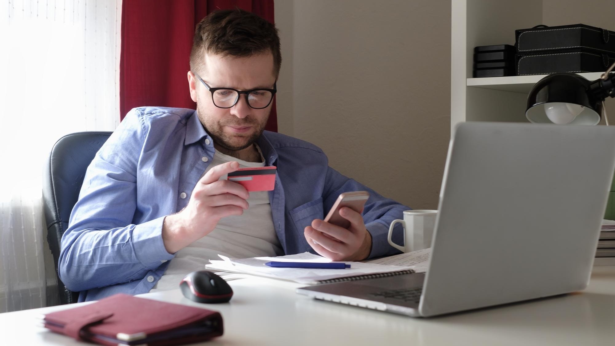Man shopping online with credit card and computer during quarantine