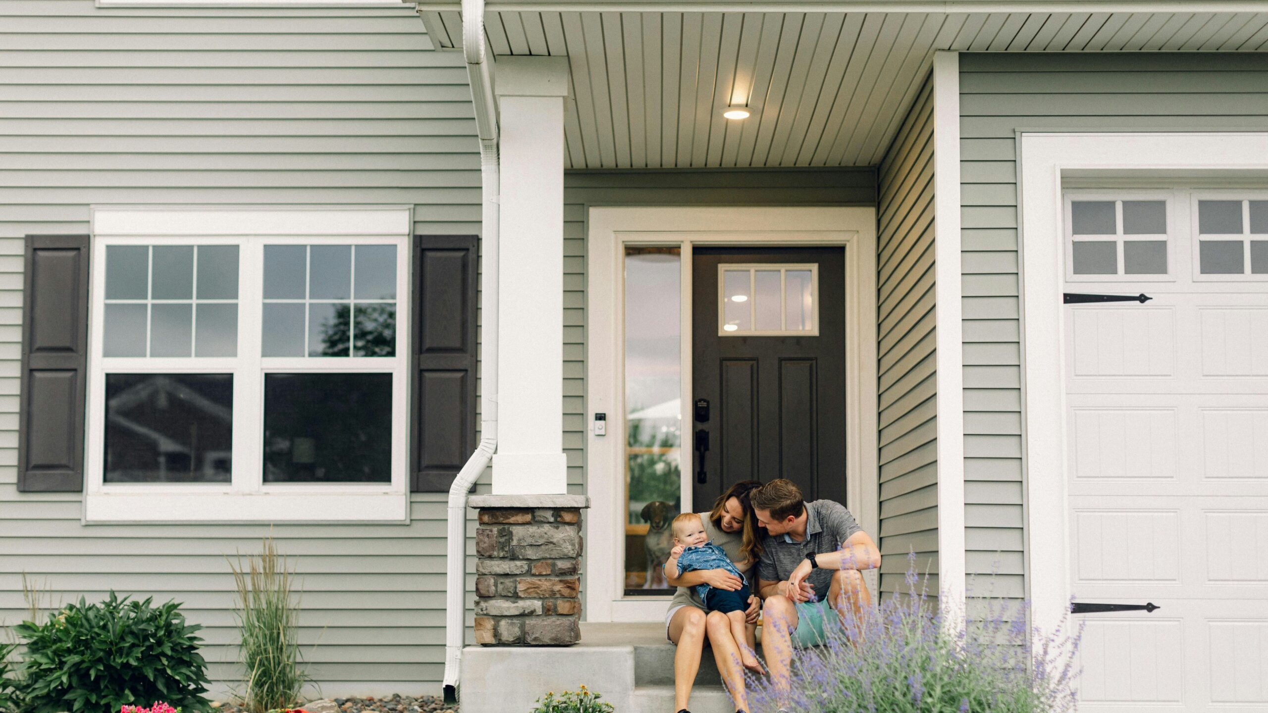 a couple of people that are sitting in front of a house