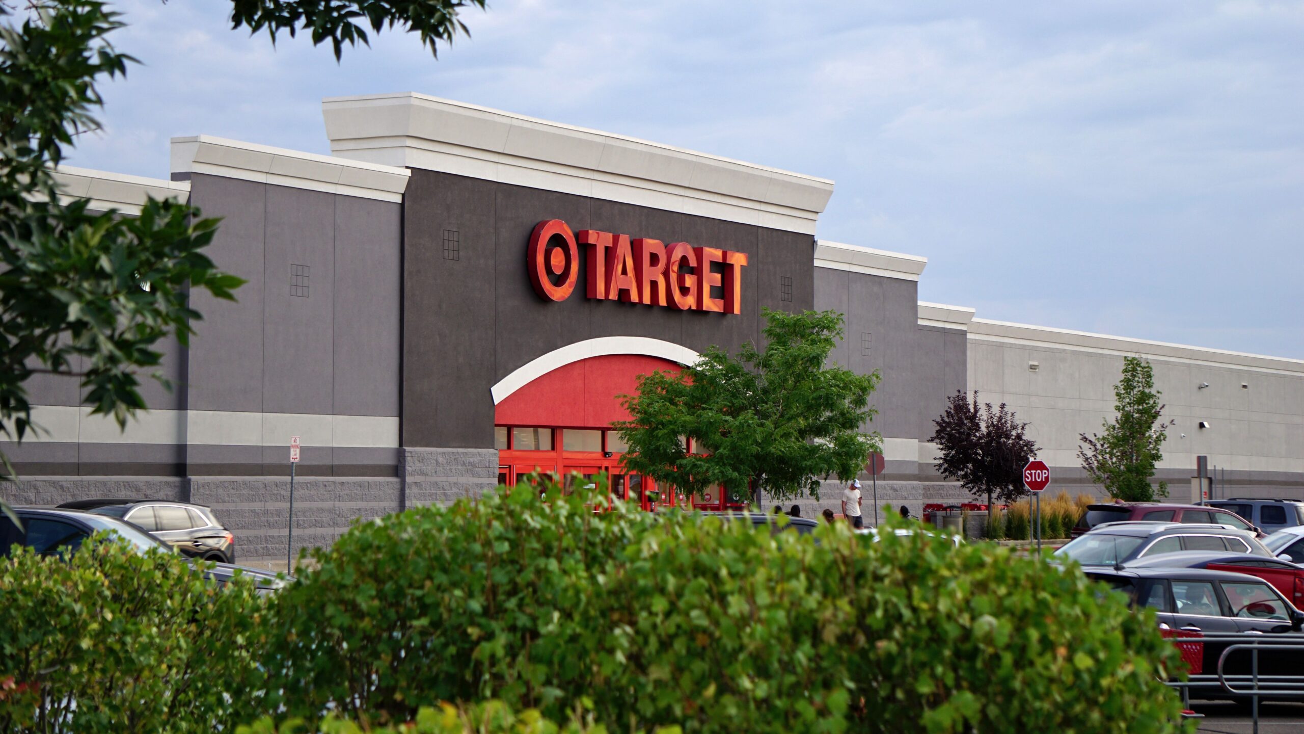 View of a Target store with parking lot, featuring signage and greenery.