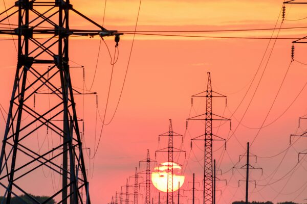 silhouette of electric post during sunset
