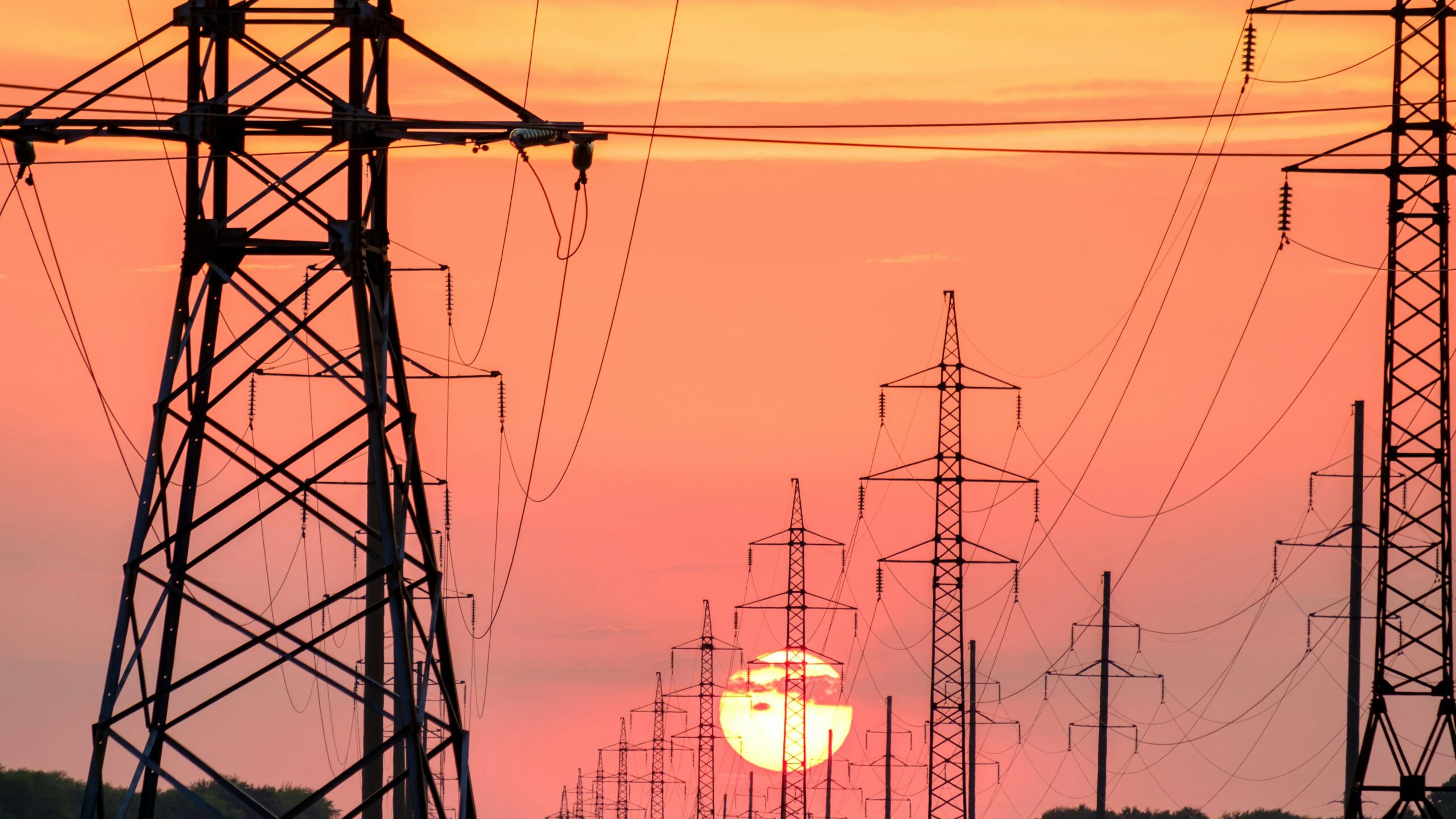 silhouette of electric post during sunset