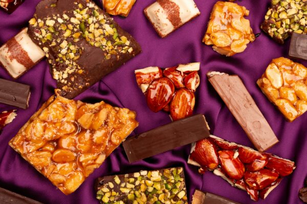 Assortment of chocolate bars and sweets on purple fabric