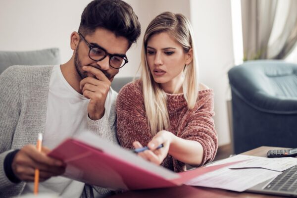 Couple checking their bills at home