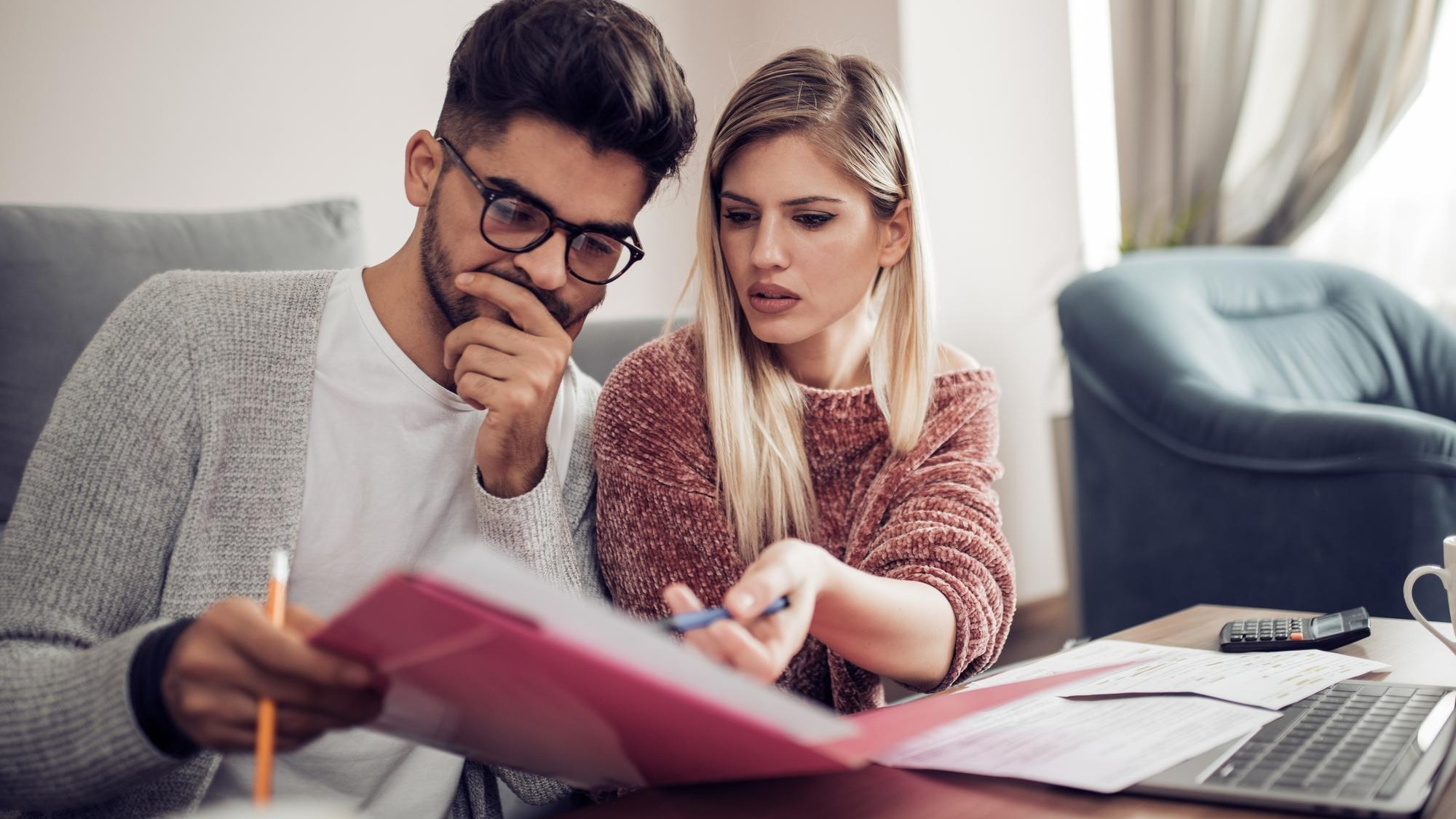 Couple checking their bills at home