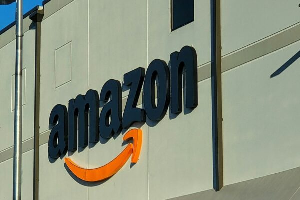 an amazon store with a person sitting in front of it