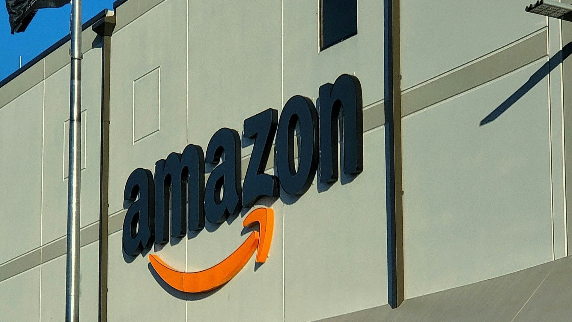 an amazon store with a person sitting in front of it