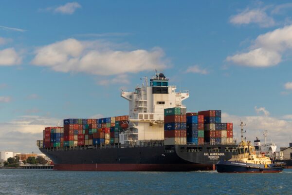 cargo ship on sea under blue sky during daytime