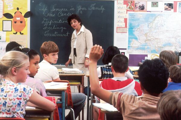 woman standing in front of children