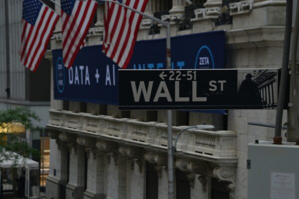 a street sign on wall street in new york city