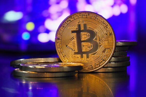 a bit coin sitting on top of a pile of coins