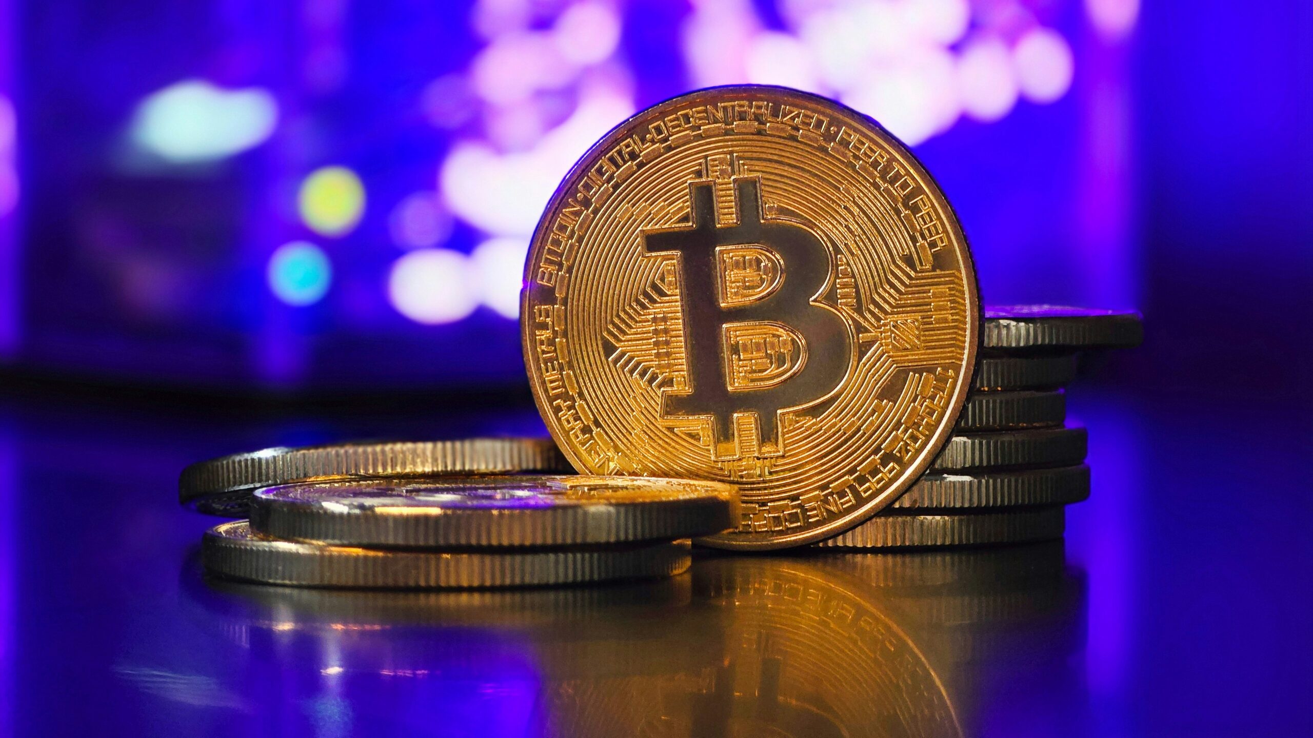 a bit coin sitting on top of a pile of coins
