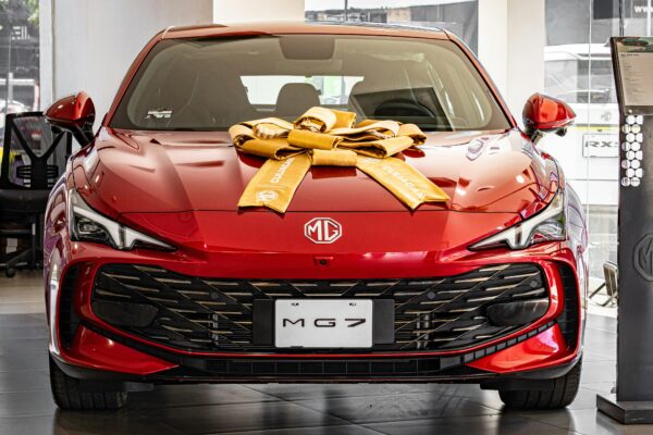 Red mg 7 car decorated with a large gold bow.