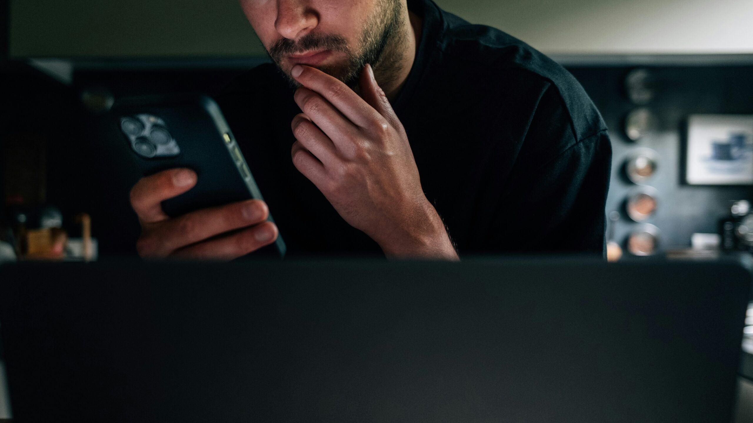 a man sitting in front of a laptop computer