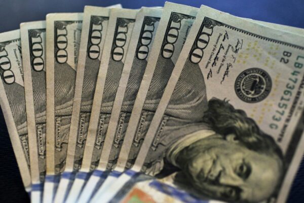 a stack of twenty dollar bills sitting on top of a table