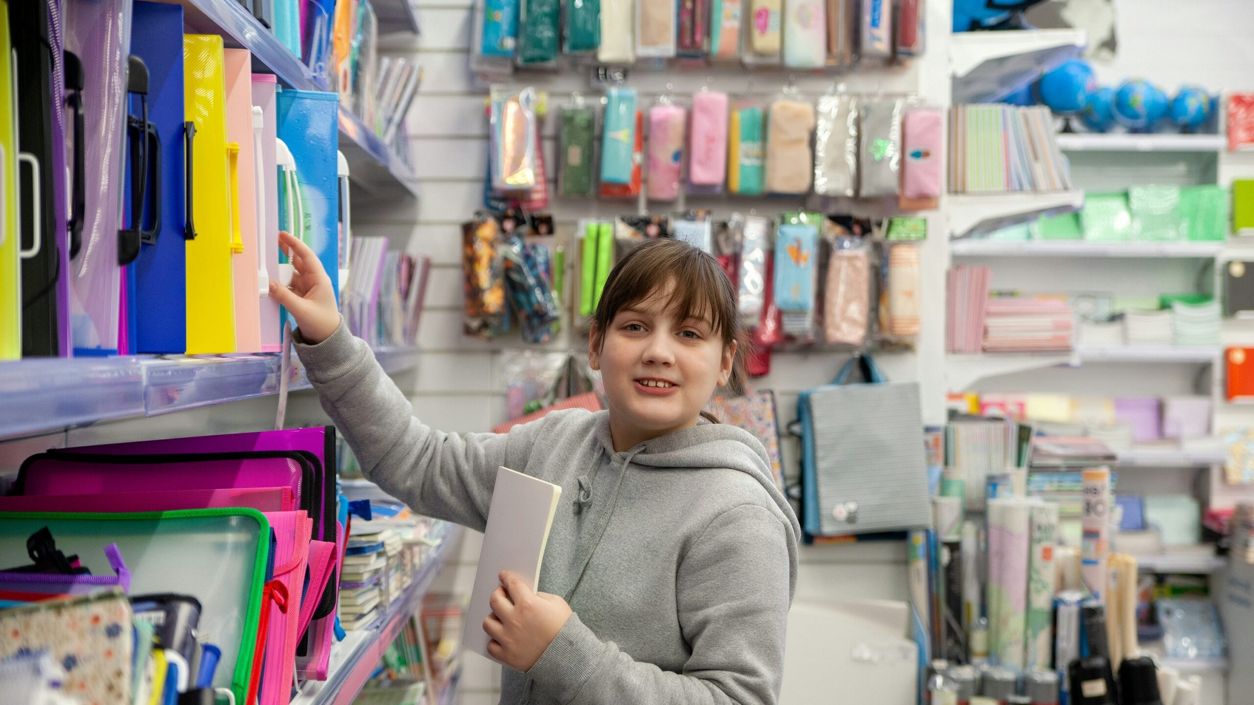 a person holding a book in a store