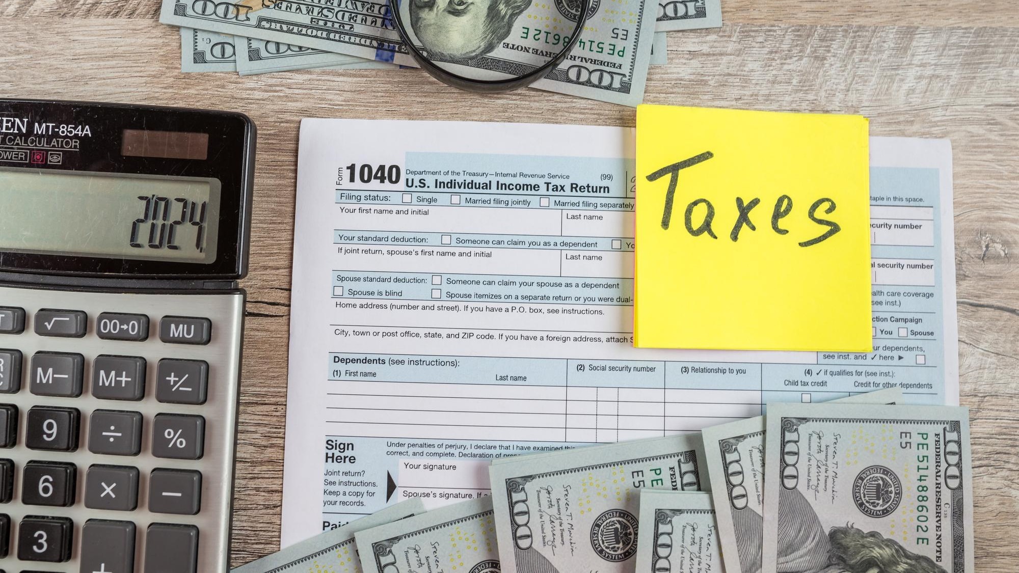 1040 tax form on a wooden table Tax time Financial concept