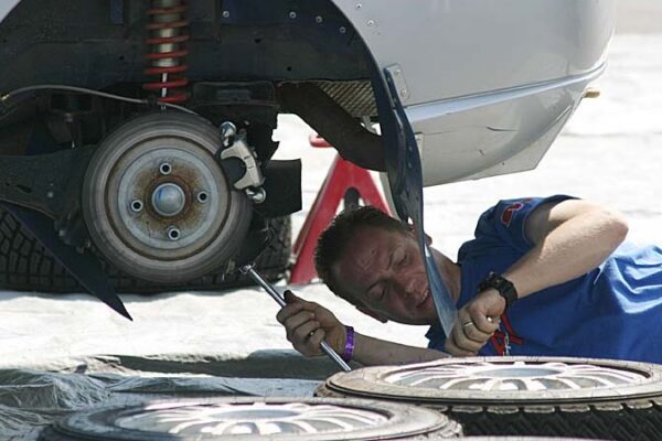 An auto mechanic works on a rally car at the 2003 Ojibwe Rally in Bemidji, MN.