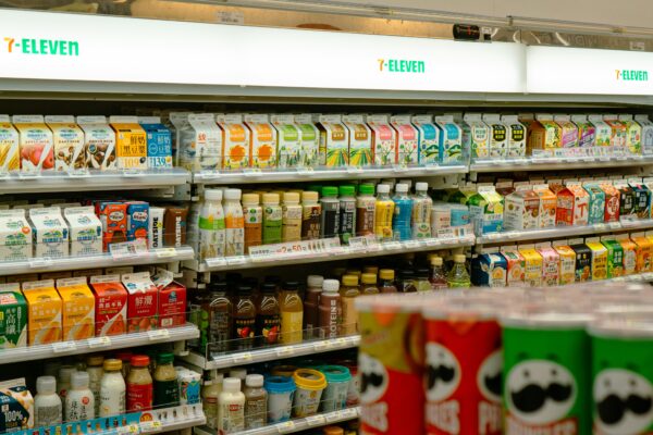 Shelves of snacks and drinks inside a 7-eleven.