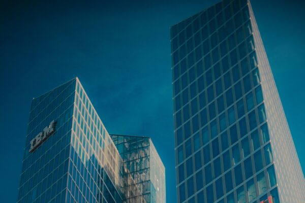 Modern glass skyscrapers with ibm and fujitsu logos.