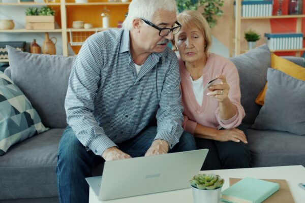 Elderly couple looking at a laptop together