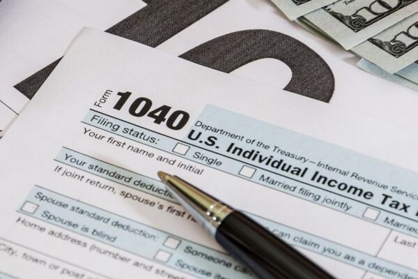 tax forms 1040 and calculator with dollars