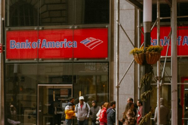 a red sports car is parked in front of a bank of america