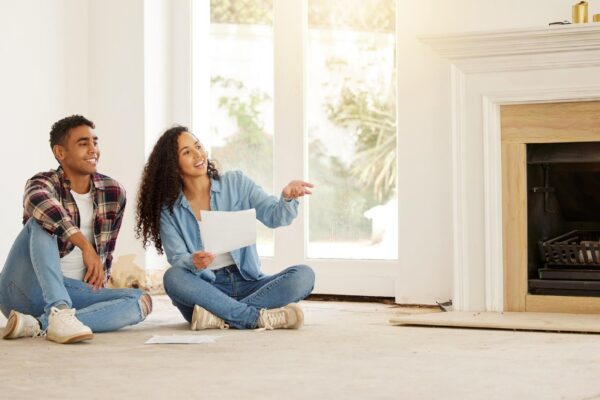 Real estate investment and planning couple with DIY renovation plan for new family house with mortgage Man and woman and happy first time homeowners with financed home loan for dream property
