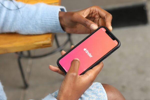 a woman sitting on a bench holding a cell phone