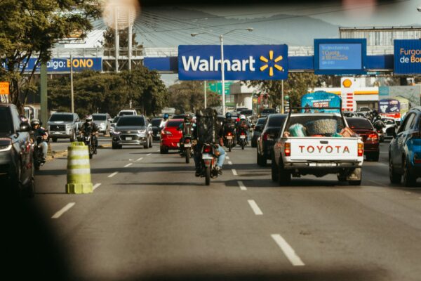 Busy road traffic passes a walmart store.
