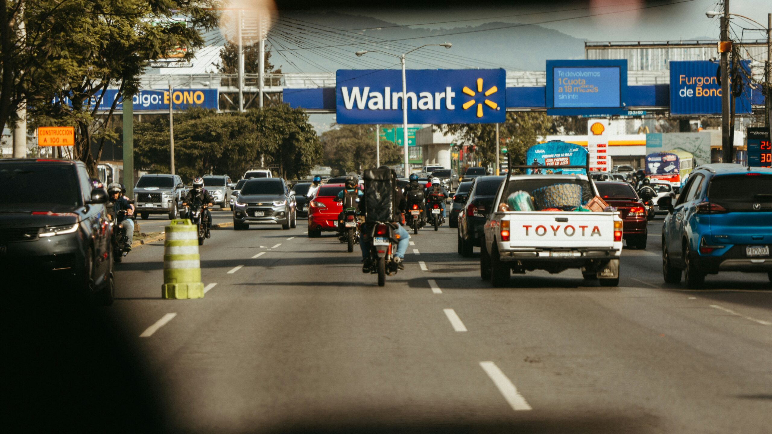 Busy road traffic passes a walmart store.