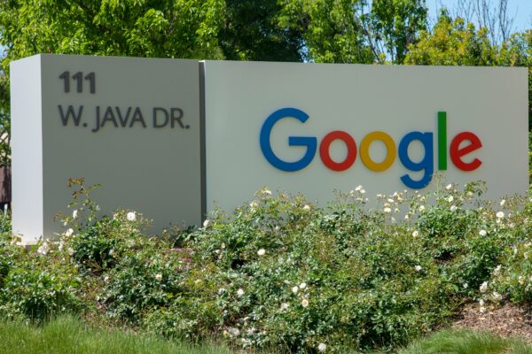 a google sign in front of some bushes and trees