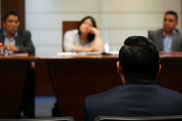 man in black shirt sitting beside woman in white shirt