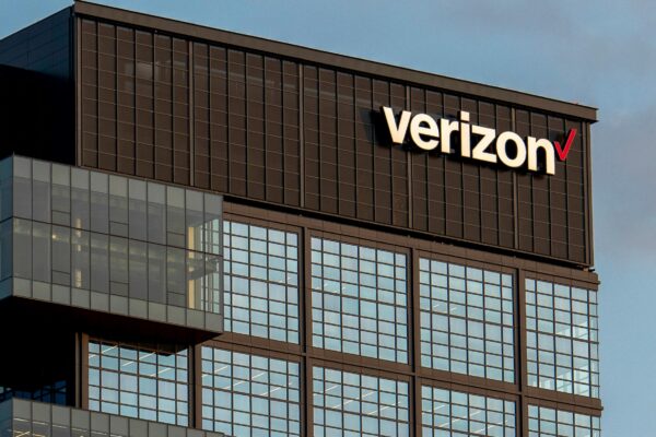 a very tall building with a verizon sign on top