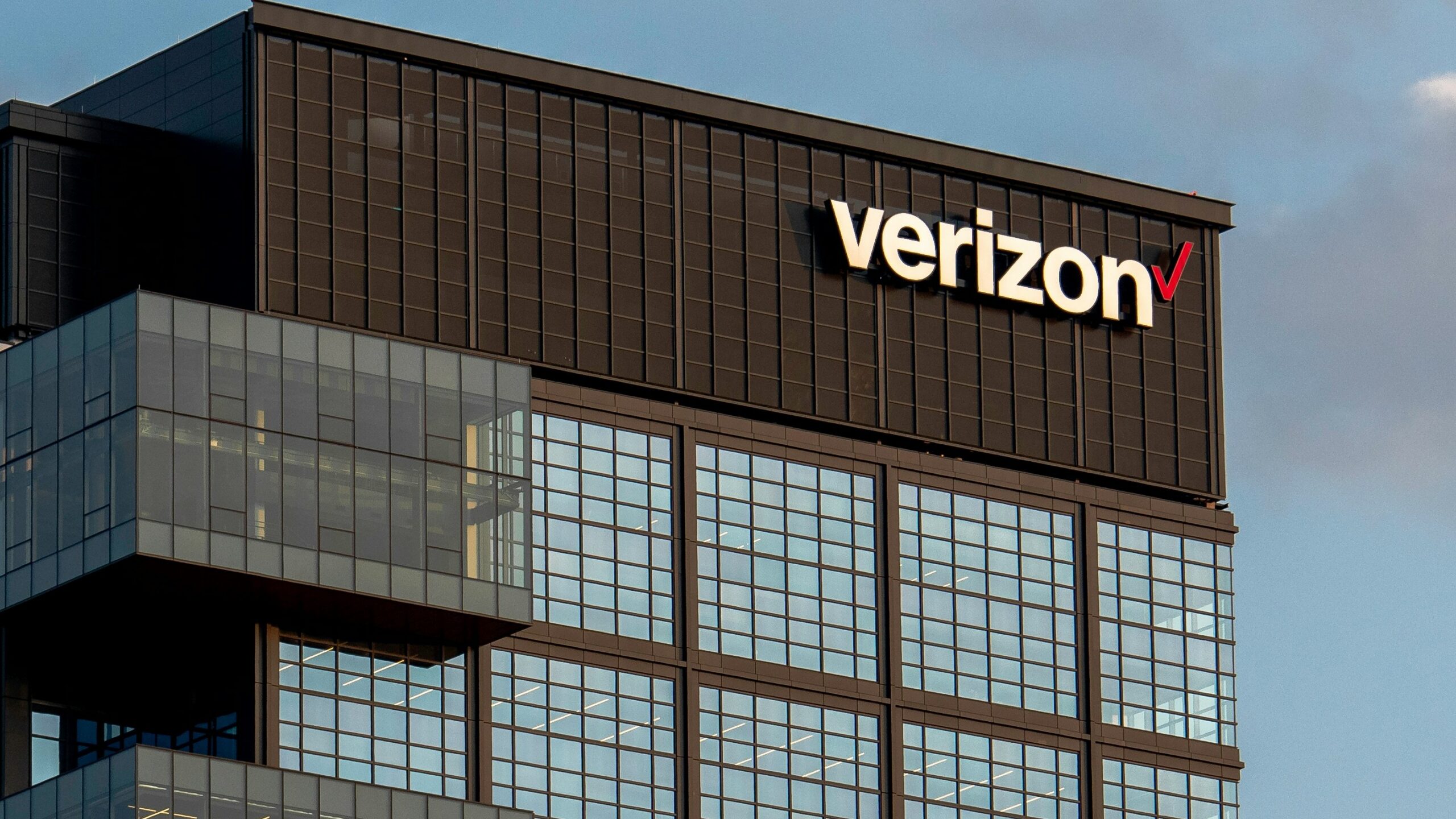 a very tall building with a verizon sign on top