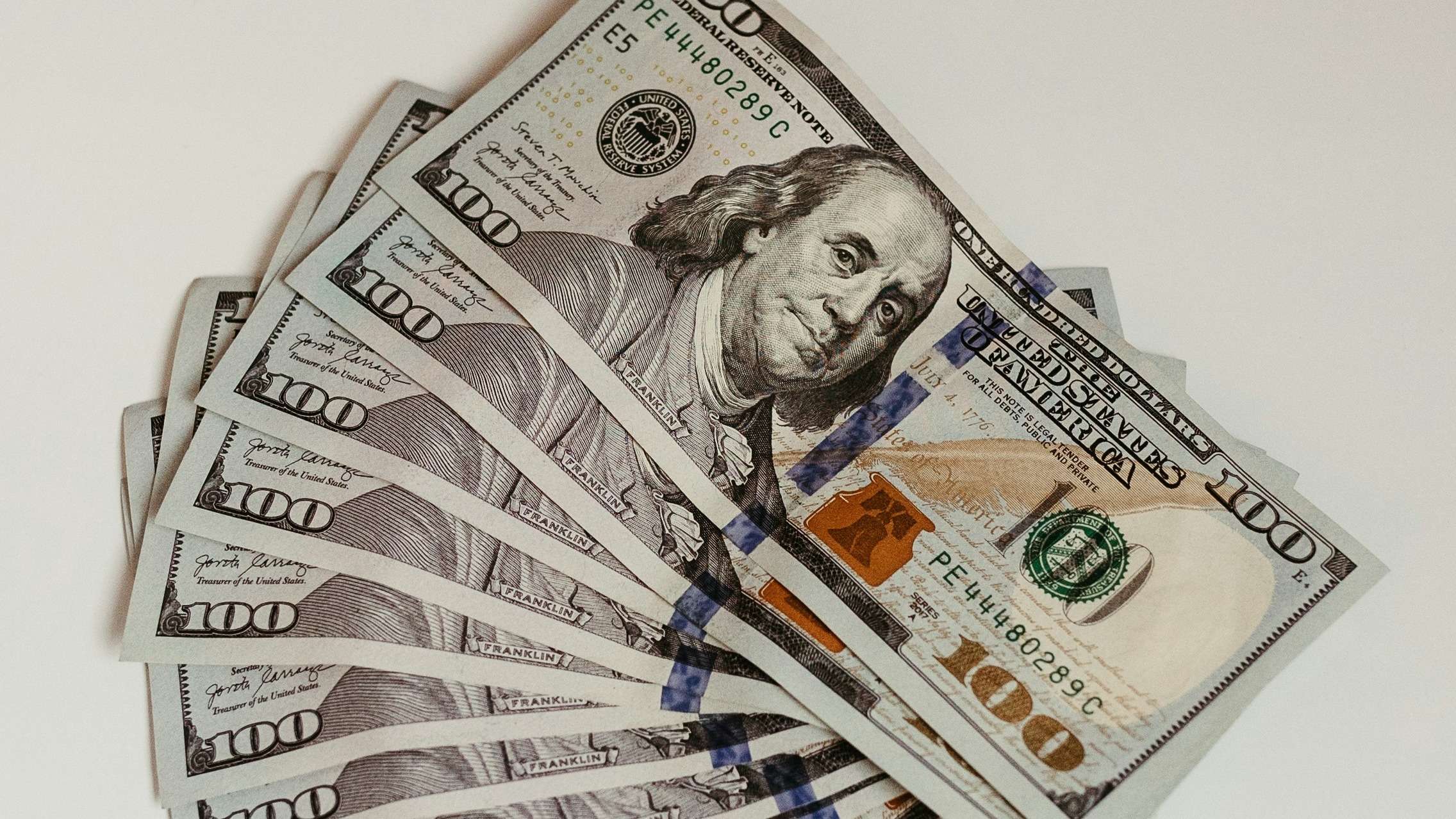 a stack of twenty dollar bills sitting on top of each other