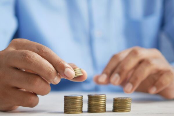 a person stacking coins on top of a table