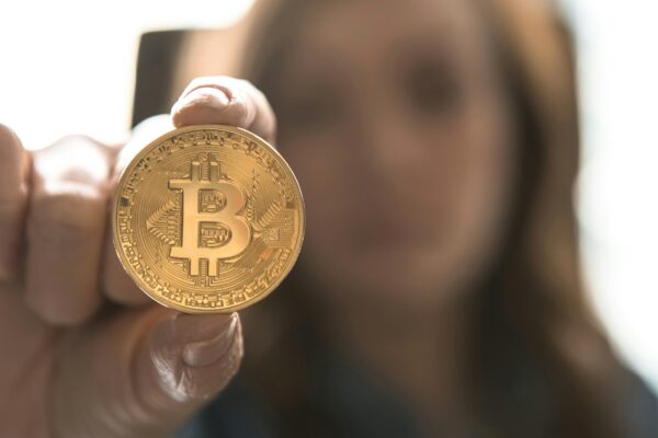 woman holding Bitcoin