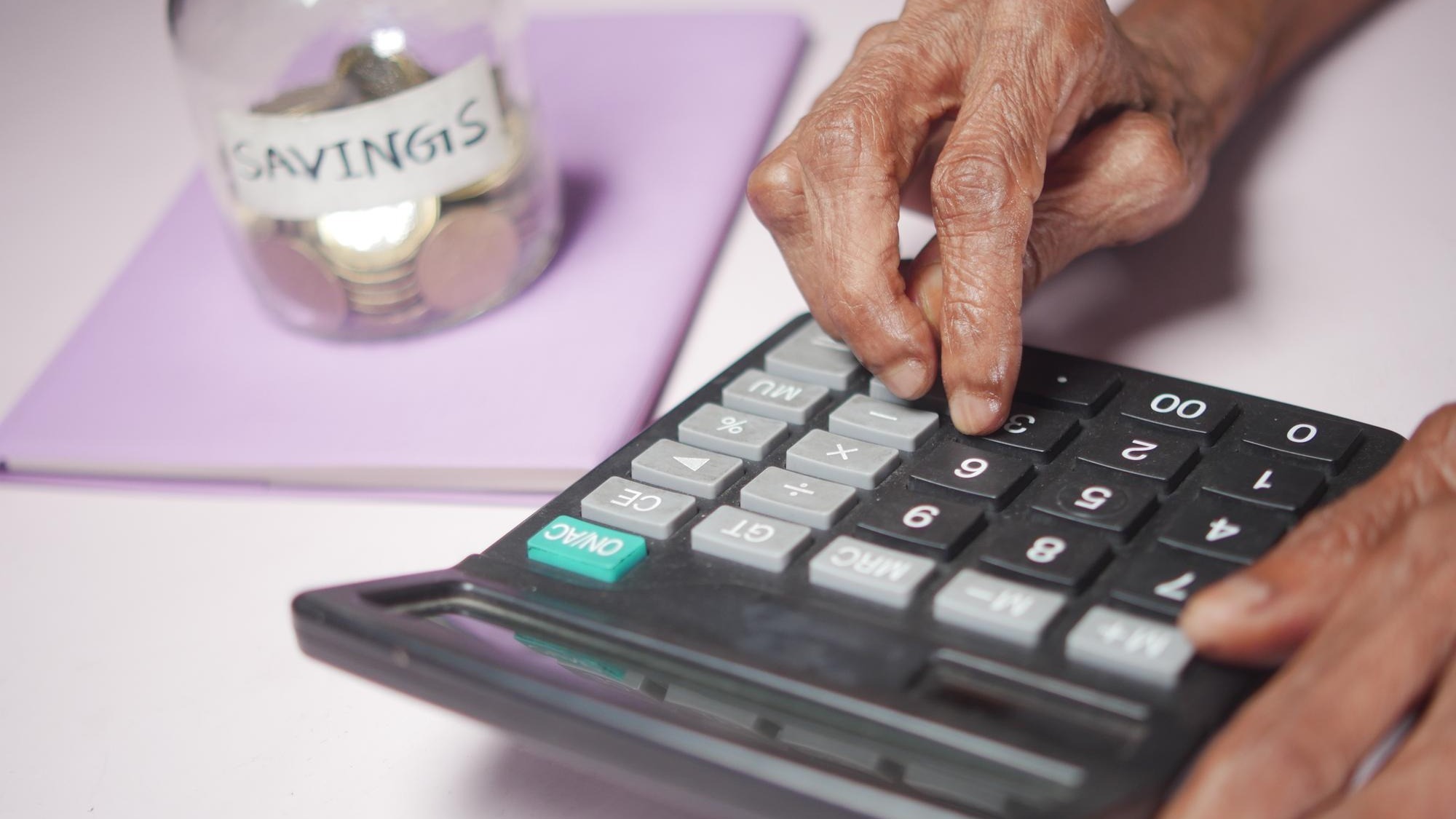 Senior women hand using calculator on desk