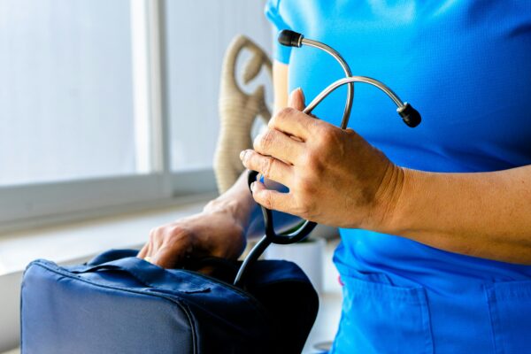a woman in a blue scrub suit holding a stethoscope