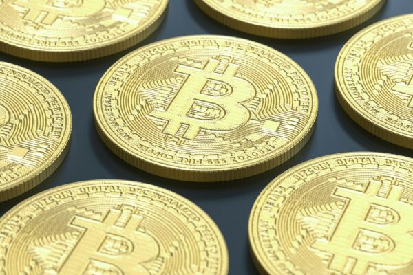 a pile of gold bitcoins sitting on top of a table