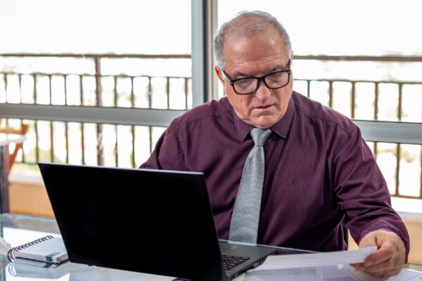 Elderly man working at home during pandemic